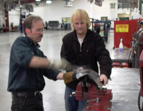 Josh Bulloch assisting a Wyotech instructor smoothing a part